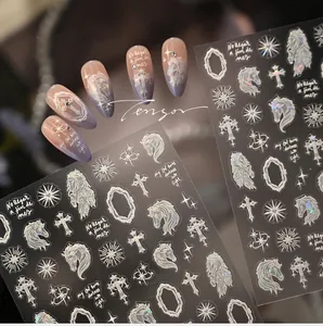 Detail of holographic unicorn and baroque cross nail stickers with iridescent finish