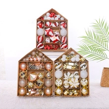 Detail of Christmas ornament set in house-shaped box with various red and white baubles