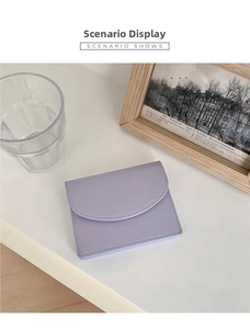 Detail of lavender minimalist card holder featuring a curved flap and neat stitching