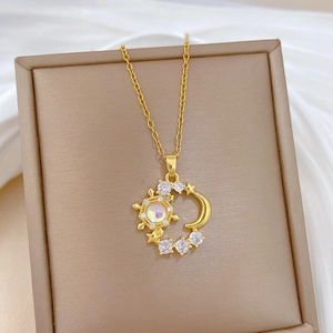 Detailed macro shot of celestial sun and moon pendant set with sparkling crystals and stones