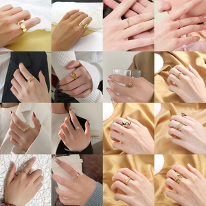 Collage of 16 gold-plated rings with various designs like hearts and geometric shapes