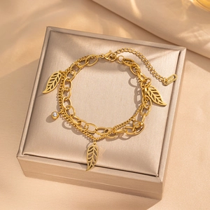 Double-layered 18KGP gold chain bracelet with hollow leaf charms and sparkling diamond accent