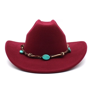 Detail of burgundy wool cowboy hat featuring a braided band and turquoise stone accents