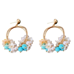 Elegant gold flower earrings with white petals and blue crystal beads on white background