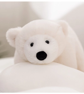 Close-up of soft white plush polar bear stuffed toy with fluffy texture and cute face