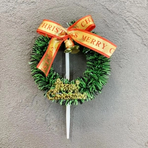 Detailed Christmas wreath cake topper with red ribbon, gold bell and Merry Christmas sign