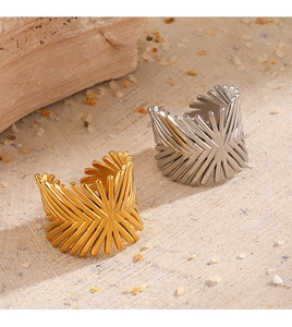 Detail of minimalist geometric open rings in gold and silver finish on stone base