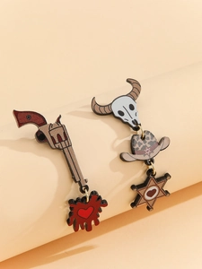 Detail of asymmetric western cowboy earrings with revolver, skull and leopard hat charms