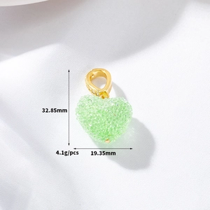 Detail view of light green heart pendant with gold bail and dimensions of 32.85x19.35mm