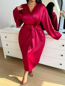 Detail of burgundy satin robe showing premium silk texture and waist tie design