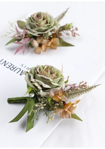 Detail of forest style boutonniere with green rose, silk ribbon and sparkling rhinestone