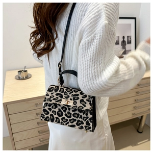 Fashionable leopard print handbag with black strap and golden twist-lock buckle detail