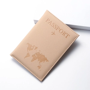 Detail of world map embossed pattern on a beige PU leather travel passport cover