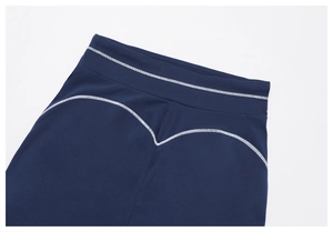 Detail view of high-waist fitness shorts featuring white heart-shaped contrast stitching