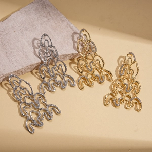 Modern wavy geometric long drop earrings in gold and silver finish with sparkling zircons