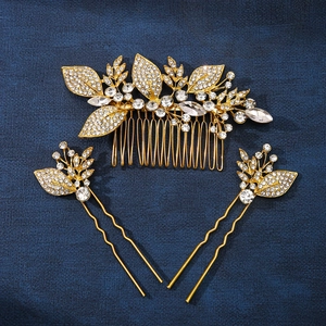 Close-up of a 3-piece bridal hair set with gold rhinestone leaves and sparkling crystals