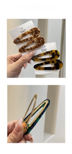 Macro detail of tortoise shell acetic acid hair clip with golden metal alligator clip base