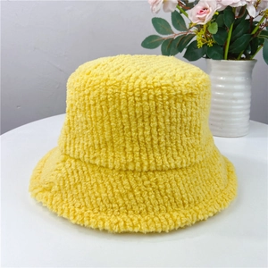 Detail of yellow plush fleece bucket hat showing thick lamb wool texture and warm material
