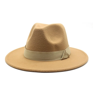 Macro shot of wide brim camel wool fedora hat showing textured felt fabric and ribbon detail