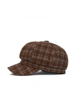 Detail view of brown plaid newsboy hat featuring vintage British checkered pattern and wool texture