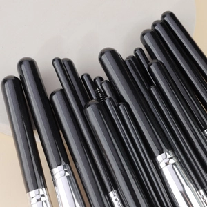 Detail of 25-piece makeup brush set with black handles and silver aluminum ferrules