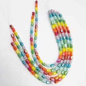 Colorful faceted cylindrical glass beads for DIY jewelry and phone chains on white background