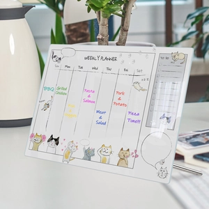 Macro shot of acrylic weekly planner with cat illustrations and metal support stand