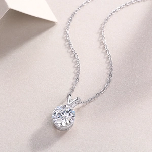 Detail view of round brilliant-cut moissanite pendant on a silver-plated chain