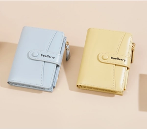 Close-up of light blue and yellow leather bifold wallets with zipper and stitching detail