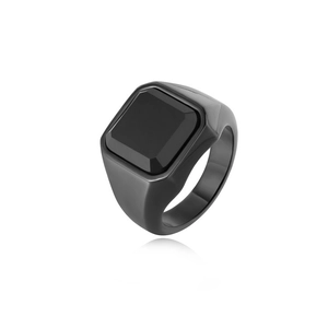 Detail of minimalist black titanium steel signet ring with square gemstone and matte finish