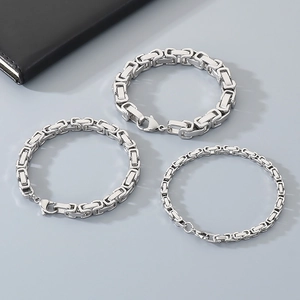 Three widths of silver Byzantine chain bracelets in titanium steel displayed on grey background