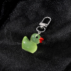 Cute translucent light green resin duck keychain with a silver metal clasp for bags
