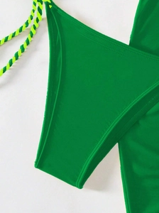Detail view of emerald green bikini bottom with braided yellow drawstring ties