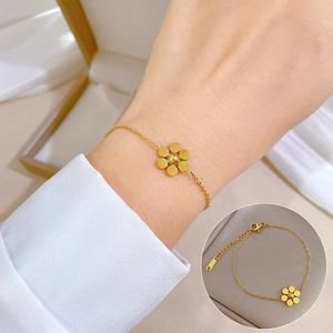 Titanium steel bracelet featuring a minimalist golden flower charm and bead chain link