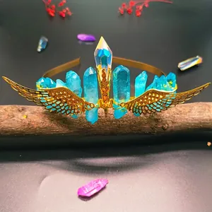 Close-up of handmade gold wings and colorful crystals on an enchanted bridal headband