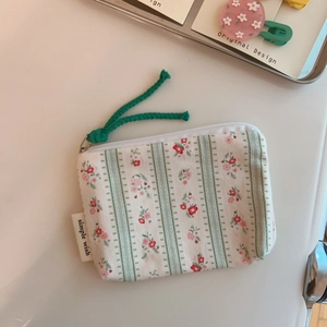 Detail of floral and striped canvas coin purse with zipper and simple wish label