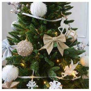 Detailed view of champagne sequins and white plush foam balls hanging on a Christmas tree