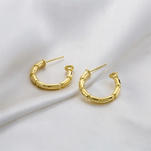 Minimalist 14K gold plated bamboo texture hoop earrings on white silk background
