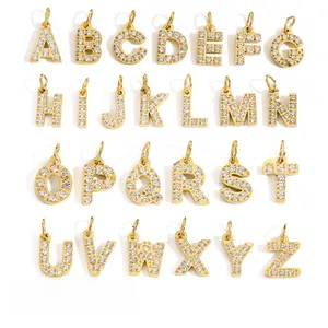 Detailed grid view of 26 cubic zirconia alphabet charms in 14K gold and silver finishes