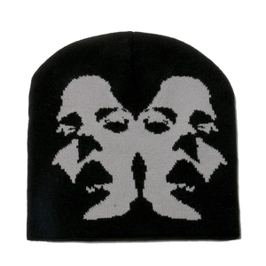 Close-up of black knitted beanie featuring gray jacquard symmetric face profile patterns