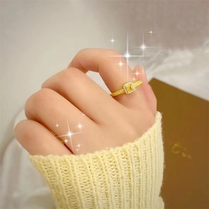 Elegant 18k gold plated ring with square yellow gemstone and diamond halo on model's hand