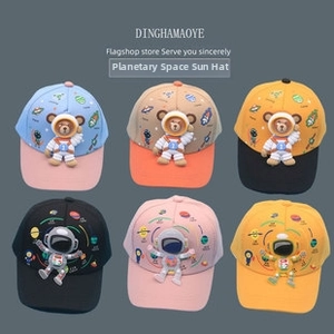 Detailed comparison of kids knit caps with astronaut bear motifs and planet patterns