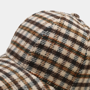 Detailed close-up of classic plaid pattern stitching on a retro tweed baseball cap