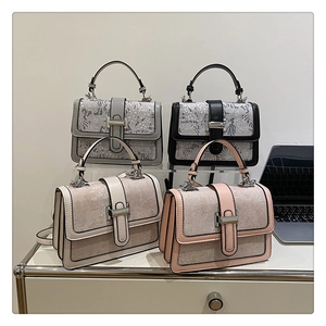 Detail showing lace texture and metal bar buckle on stylish square crossbody bags