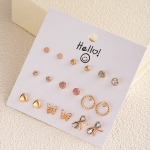Detail of 9-pair rose gold earring set with butterflies, hearts, and crystals on card