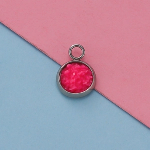 Detailed macro view of a 12mm stainless steel pendant with bright pink texture inlay