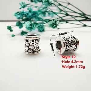 Macro detail of antique silver spacer beads with engraved cloud patterns and dimensions
