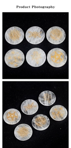 Detailed view of six white quartz energy stones with gold engraved celestial symbols