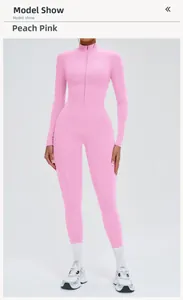 Front full-body model view of peach pink long-sleeve yoga jumpsuit with zip neckline