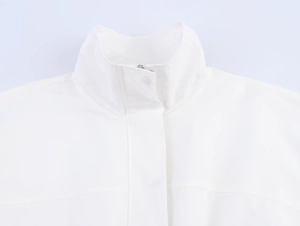 Detailed close-up of a modern white high-collar jacket with a hidden placket and fine seams
